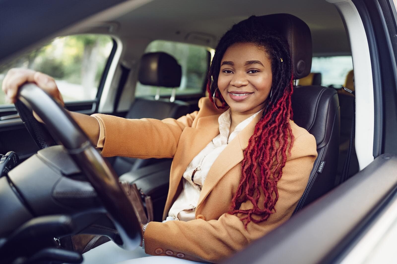 A driver smiling at the wheel